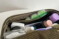 Toiletry items inside the Dagne Dover Small Seoul Dopp Kit