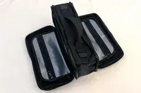 The open Cincha The Toiletry Bag with clear zippered compartments and a handle