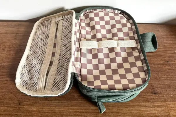 The opened State Hart Toiletry Kit with a checkered interior design