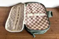 The opened State Hart Toiletry Kit with a checkered interior design