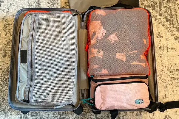 The BAGSMART Blast 4.5L Hanging Toiletry Bag inside a neatly packed suitcase