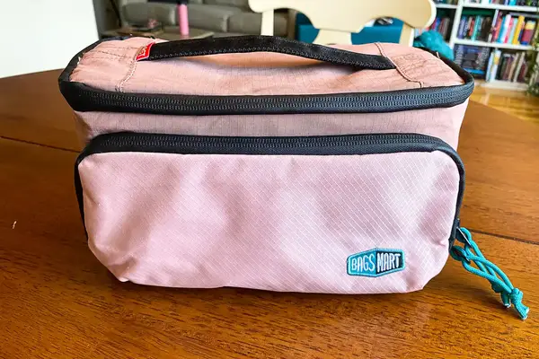 The BAGSMART Blast 4.5L Hanging Toiletry Bag on a wooden table