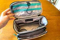 A person holds the BAGSMART Blast 4.5L Hanging Toiletry Bag open