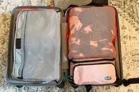 The BAGSMART Blast 4.5L Hanging Toiletry Bag inside a neatly packed suitcase