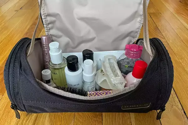 Several different toiletries inside the Briggs & Riley Baseline Executive Essentials Kit