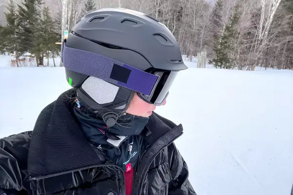A person on the slopes wearing the Smith Vantage MIPS Snow Helmet