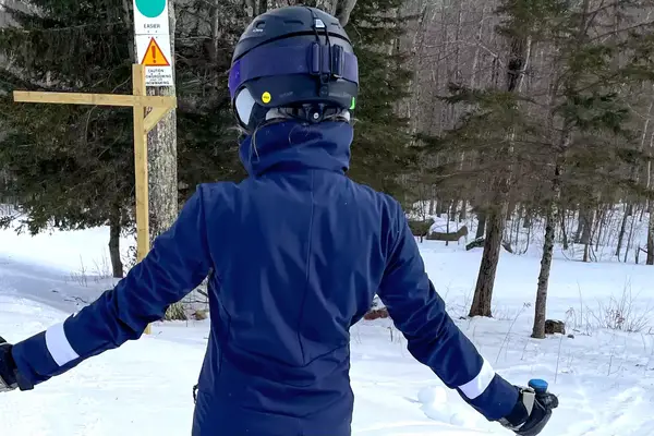 A person on the slopes wearing the Smith Vantage MIPS Snow Helmet