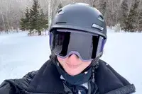 A person on the slopes wearing the Smith Vantage MIPS Snow Helmet