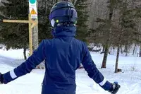 A person on the slopes wearing the Smith Vantage MIPS Snow Helmet