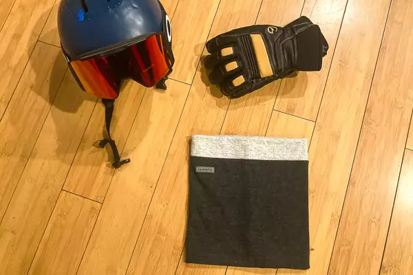 A Turtle Fur Double-layer Neck Warmer next to ski gear