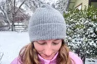 Top view of a person wearing the Quince Mongolian Cashmere Ribbed Beanie outdoors in snow