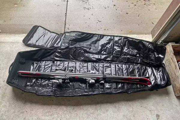 A pair of skis inside the DB Snow Roller Pro 127L