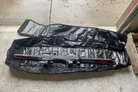 A pair of skis inside the DB Snow Roller Pro 127L