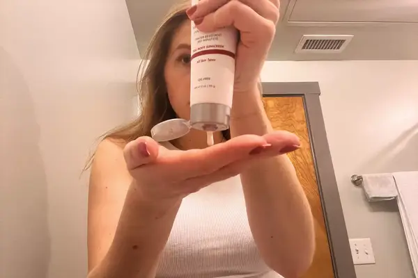 Front view of a person wearing the Aspen Collection Cirque Down Jacket outside 