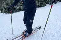 A person skis while wearing the Backcountry CrestCarver Men