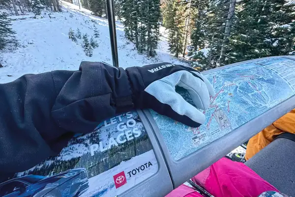 A person wears the Hestra Army Leather Heli Ski Gloves