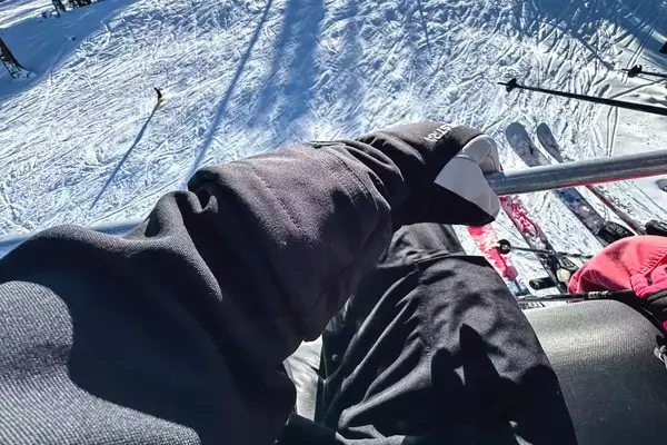 A person wears the Hestra Army Leather Heli Ski Gloves while skiing