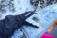 A person wears the Hestra Army Leather Heli Ski Gloves while skiing