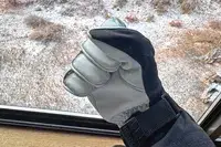 A person makes a fist while wearing the Hestra Army Leather Heli Ski Gloves