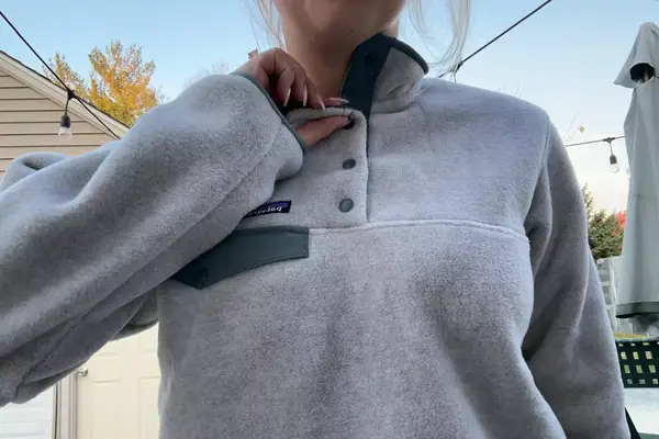 Person unbuttoning a Patagonia Women
