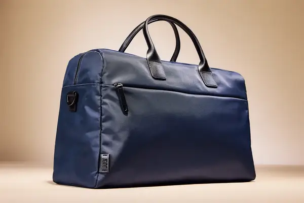 A July Carry All Weekender displayed on a light gradient background