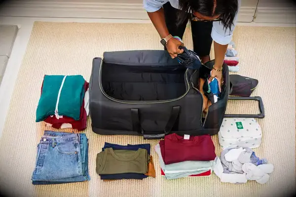 Person rolling Travelers Club Xpedition Multi-pocket Upright Rolling Duffel Bag on carpet