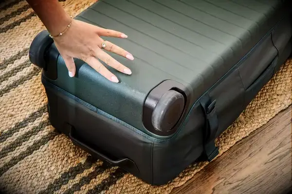 Person rolling Patagonia Black Hole Wheeled Duffel Bag 100L around cones during testing