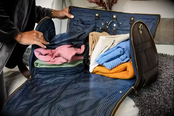 Person pushing the Eagle Creek 130L Cargo Hauler off a counter