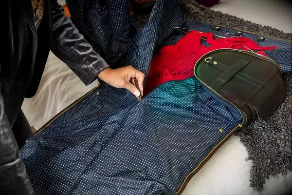 Person pulling the Eagle Creek 130L Cargo Hauler behind them over a rug