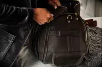 Person pushing the Eagle Creek 130L Cargo Hauler off a counter