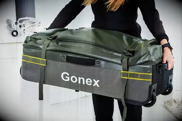 Person carrying Gonex Rolling Duffel Bag With Wheels