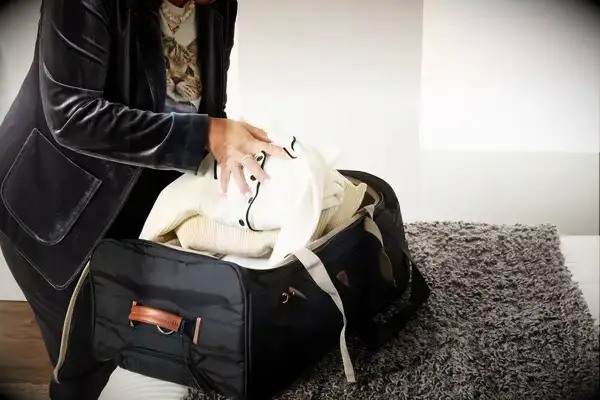 Person carrying Gonex Rolling Duffel Bag With Wheels