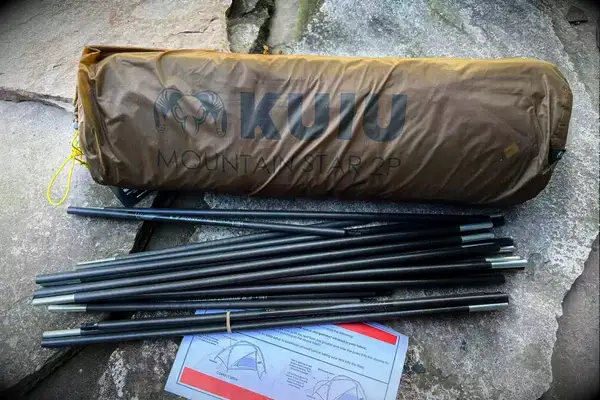 The pieces of the Kuiu Mountain Star 2 Person Tent with directions