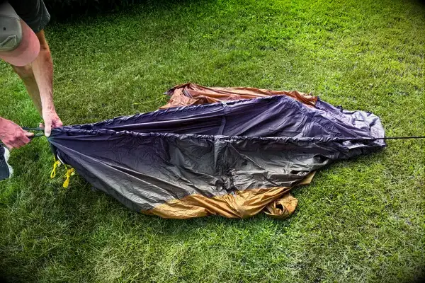 A person assembles the Kuiu Mountain Star 2 Person Tent