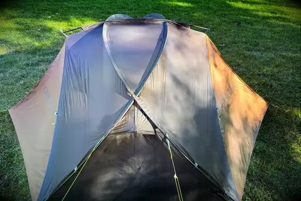 The Kuiu Mountain Star 2 Person Tent with cover on grass