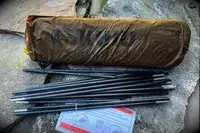 The pieces of the Kuiu Mountain Star 2 Person Tent with directions