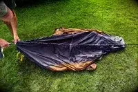 A person assembles the Kuiu Mountain Star 2 Person Tent