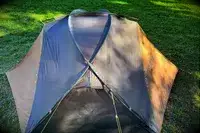 The Kuiu Mountain Star 2 Person Tent with cover on grass