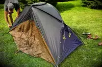 A person assembles the Kuiu Mountain Star 2 Person Tent