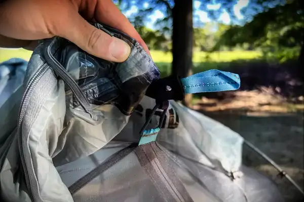 A person holds up the ties on the Sea to Summit Telos Freestanding Ultralight Tent
