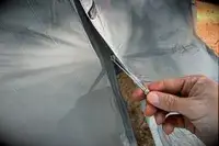 A person zips the Sea to Summit Telos Freestanding Ultralight Tent closed