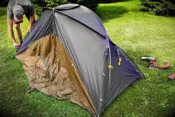 A person assembles the Kuiu Mountain Star 2 Person Tent