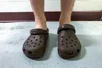 A front view of a person wearing the Crocs Classic Clogs