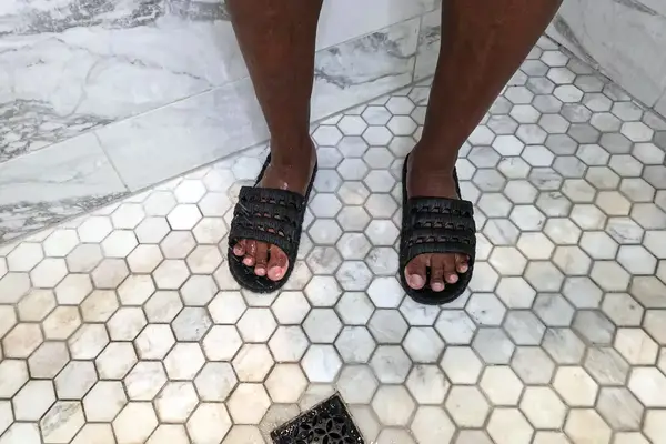 A person showers while wearing the TECS Men