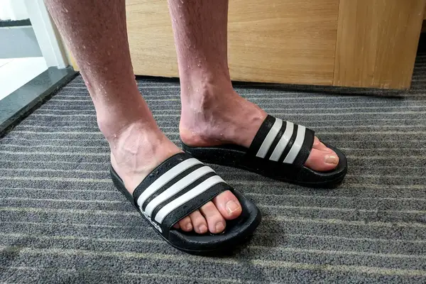 A person wears the Adidas Men