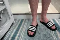 A person wears the Adidas Men