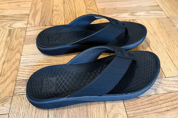 A pair of Reef The Deckhand on a wooden floor