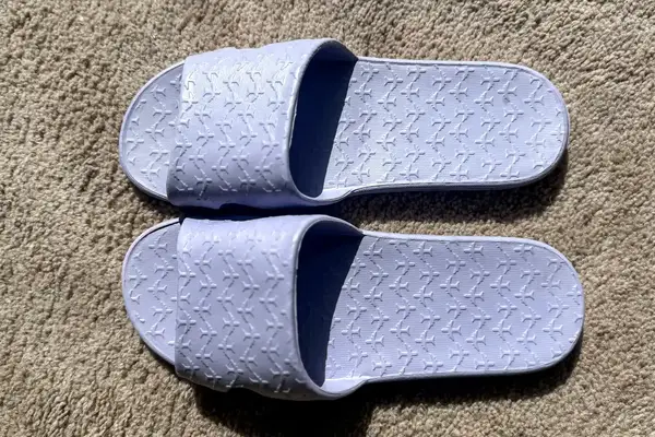 An overhead view of a pair of Anmerl Travel Slippers