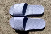 An overhead view of a pair of Anmerl Travel Slippers