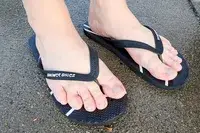 A person wears the Shower Shoez Women